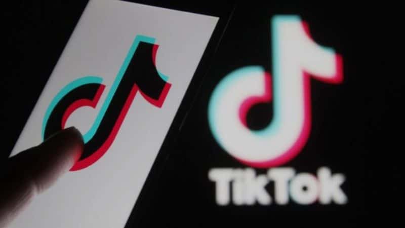 Image of a phone with the TikTok logo, featured cover of an article about how to get more likes on TikTok