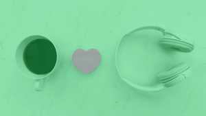 An image featuring coffee, a paper heart, and headphones, the main image for a blog about how much a small artist earns on Spotify
