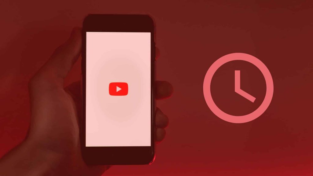 Phone with the YouTube logo next to a clock icon, featured image of the article 'How to get hours on YouTube to monetize.'