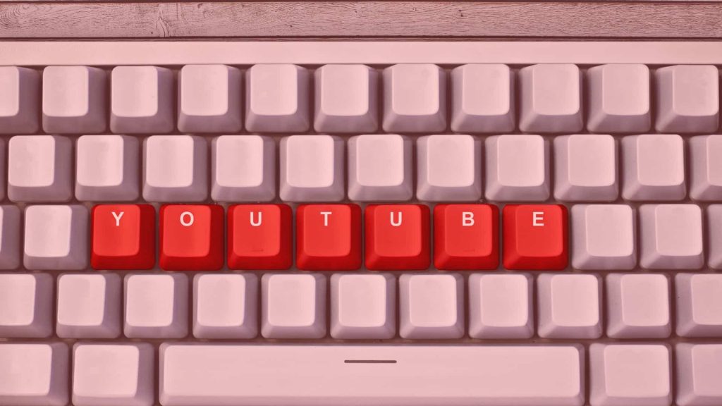 A keyboard where the keys display the word 'YouTube,' featured image of an article about how to grow a YouTube channel