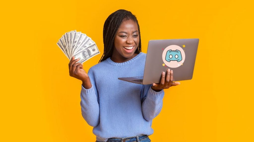 A smiling woman holding money in one hand and a computer with the Discord logo in the other