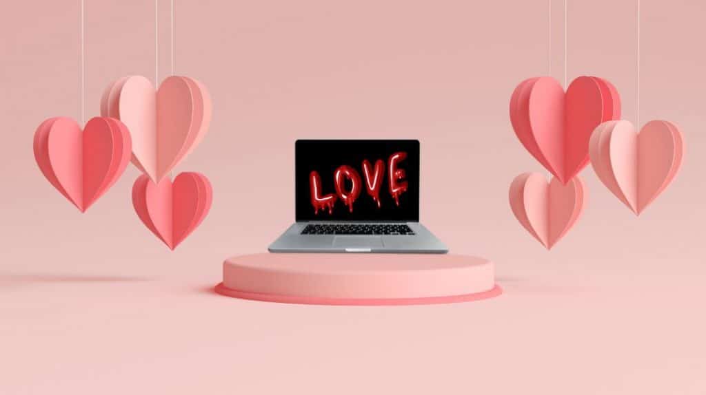 Laptop with hearts coming out on both sides and the word Love written on it